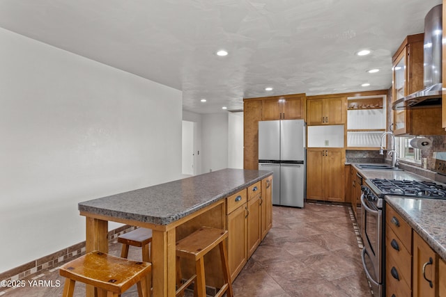 5252 US Highway 12, Yakima, WA 98908 - kitchen with appliances with stainless steel finishes, wall chimney range hood, dark countertops, recessed lighting, and a kitchen island