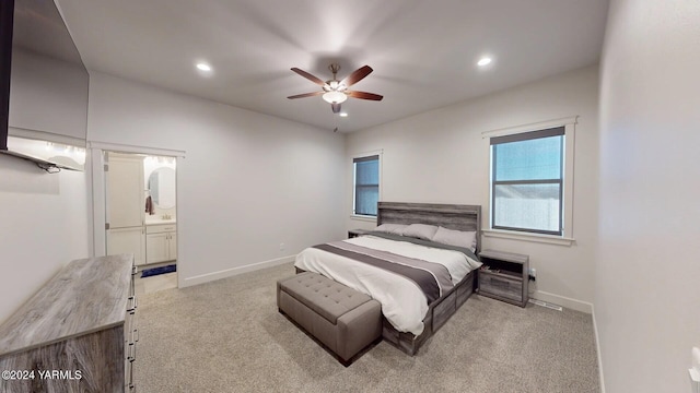 bedroom featuring ensuite bath, recessed lighting, baseboards, and light colored carpet