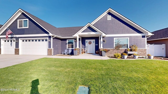 craftsman inspired home with stone siding, concrete driveway, and a front lawn