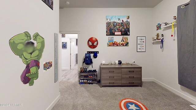 bedroom with baseboards and light colored carpet