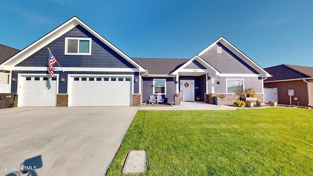 craftsman-style home with a garage, driveway, stone siding, and a front yard