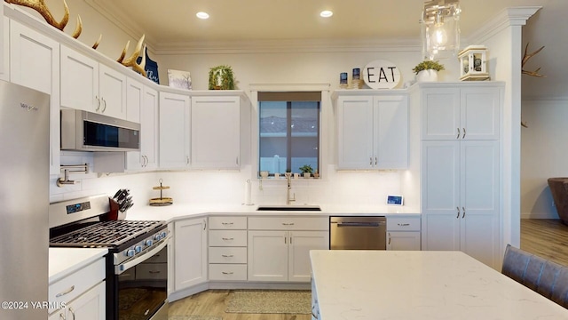 kitchen with a sink, stainless steel appliances, and light countertops