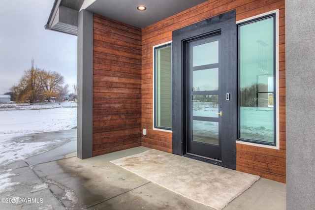 view of snow covered property entrance