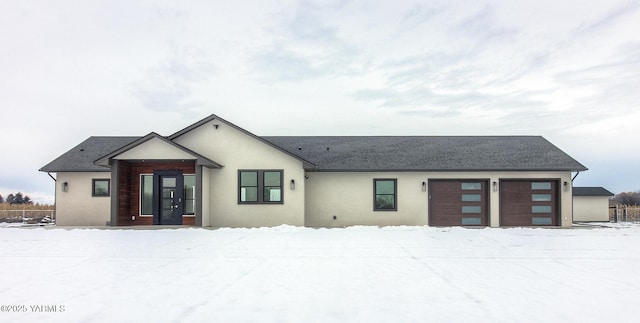 view of front facade with an attached garage and stucco siding