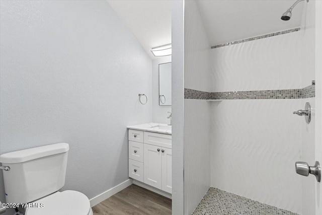 full bath featuring toilet, baseboards, wood finished floors, and vanity