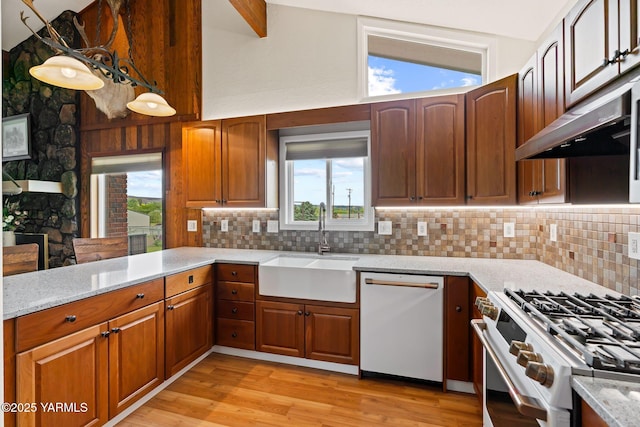 1312 Dazet Rd, Yakima, WA 98908 - kitchen with white appliances, a sink, tasteful backsplash, light stone countertops, and light wood-style floors