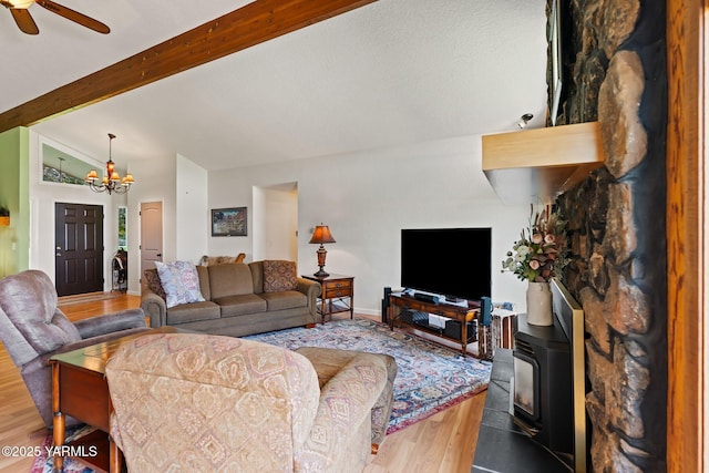 1312 Dazet Rd, Yakima, WA 98908 - living room with wood finished floors, a chandelier, a wood stove, and ceiling fan