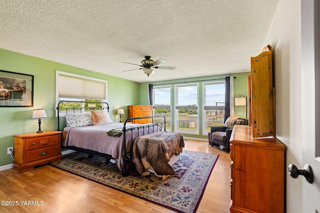 1312 Dazet Rd, Yakima, WA 98908 - bedroom featuring a textured ceiling, wood finished floors, and ceiling fan