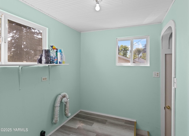 laundry room featuring baseboards, hookup for an electric dryer, wood finished floors, and laundry area