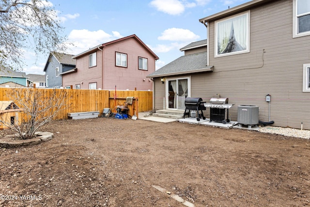 2705 Garrett St, Yakima, WA 98902 - back of property featuring a shingled roof, a fenced backyard, and cooling unit