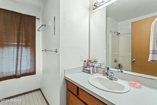 2705 Garrett St, Yakima, WA 98902 - bathroom featuring shower / bathing tub combination, vanity, and baseboards