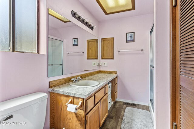5502 Bristol Way, Yakima, WA 98908 - full bathroom with toilet, visible vents, wood finished floors, and a shower with shower door