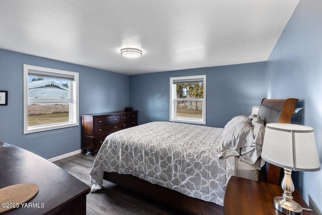 bedroom featuring baseboards and wood finished floors