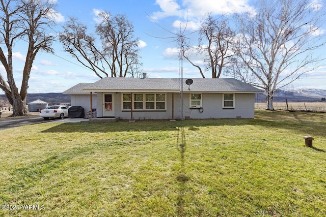 single story home with a garage, driveway, and a front lawn