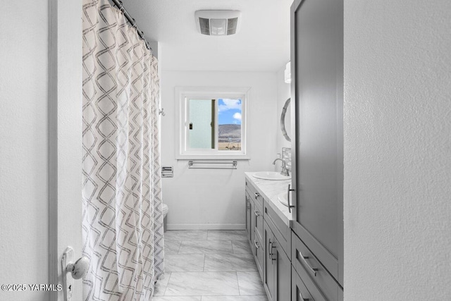 bathroom with visible vents, baseboards, marble finish floor, and vanity