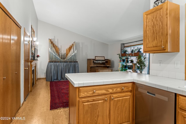 609 Jade Pl, Yakima, WA 98908 - kitchen featuring dishwasher, a peninsula, light wood-type flooring, brown cabinets, and lofted ceiling