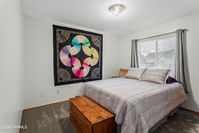 bedroom featuring dark colored carpet and baseboards