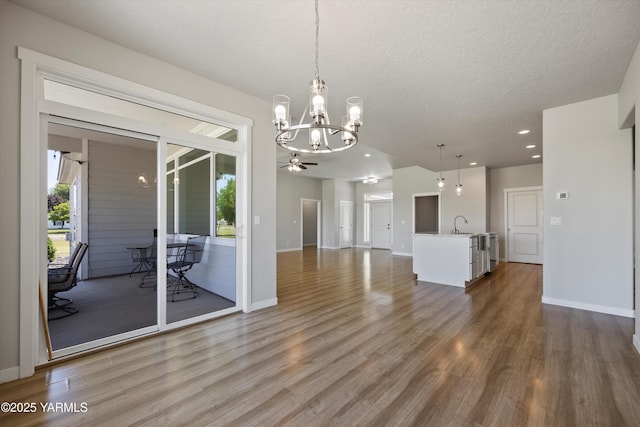 172004 NW Dogwood Rd, Prosser, WA 99350 - unfurnished dining area featuring a chandelier, wood finished floors, a ceiling fan, baseboards, and recessed lighting