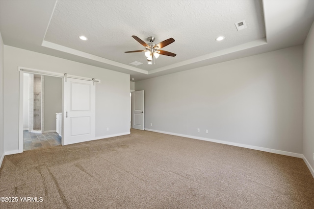 172004 NW Dogwood Rd, Prosser, WA 99350 - unfurnished bedroom featuring a tray ceiling, carpet floors, baseboards, recessed lighting, and connected bathroom