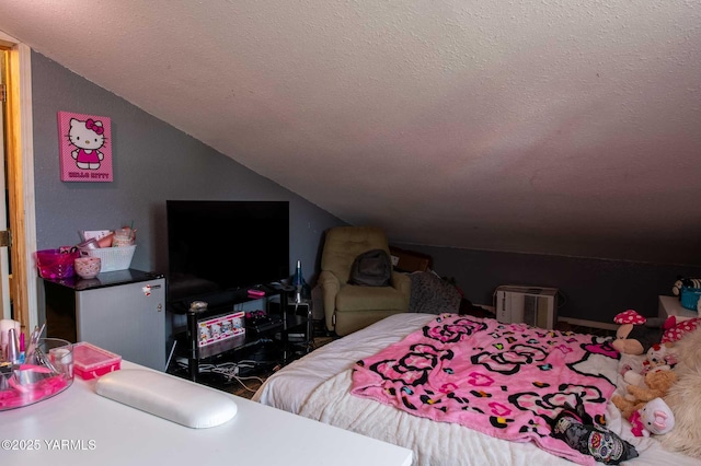 bedroom with vaulted ceiling and a textured ceiling