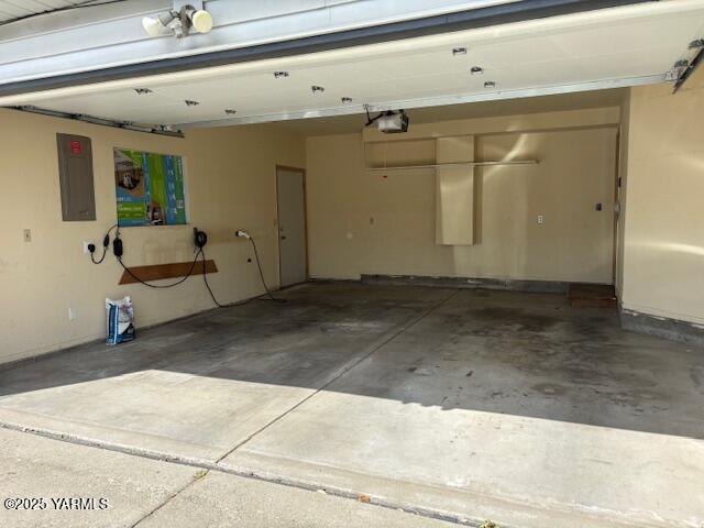 garage featuring a garage door opener and electric panel