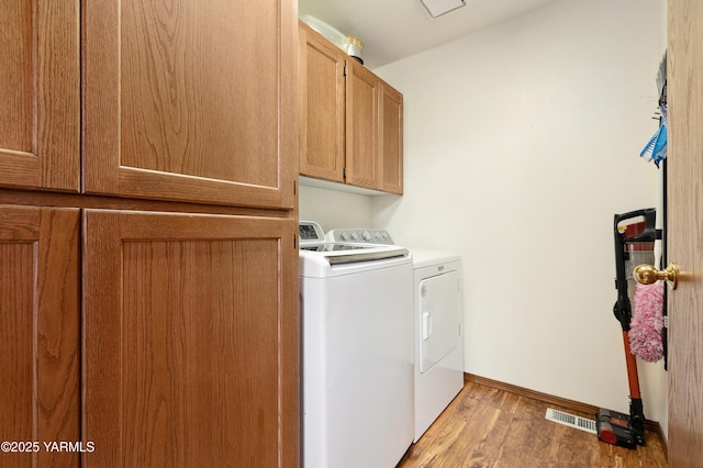 101 N 48th Ave Unit 31A, Yakima, WA 98908 - laundry area with cabinet space, washing machine and dryer, and wood finished floors
