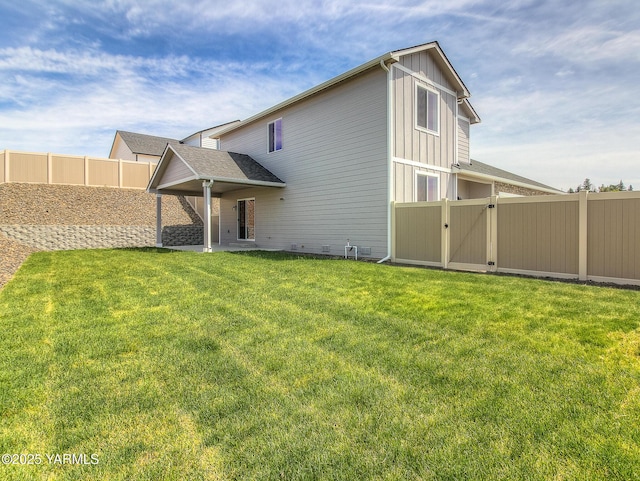302 N 90th Ave, Yakima, WA 98908 - rear view of house featuring a gate, a fenced backyard, a patio, and board and batten siding
