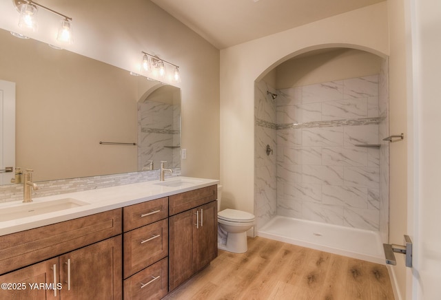 302 N 90th Ave, Yakima, WA 98908 - bathroom with double vanity, a marble finish shower, backsplash, and wood finished floors