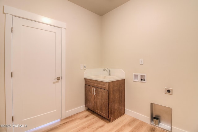 302 N 90th Ave, Yakima, WA 98908 - laundry area featuring electric dryer hookup, light wood-style floors, hookup for a washing machine, and cabinet space