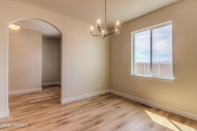 302 N 90th Ave, Yakima, WA 98908 - empty room with arched walkways, wood finished floors, and a chandelier
