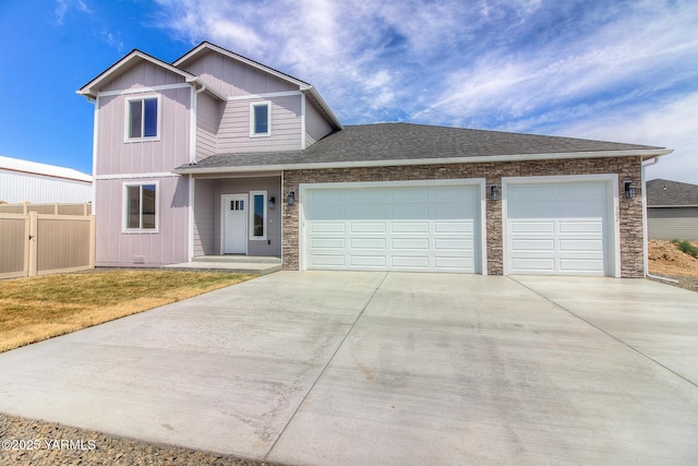 302 N 90th Ave, Yakima, WA 98908 - view of front of property with concrete driveway, a garage, stone siding, and roof with shingles