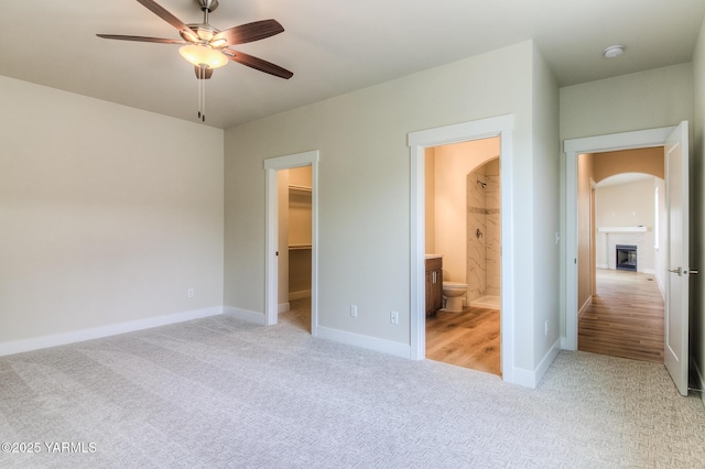 302 N 90th Ave, Yakima, WA 98908 - unfurnished bedroom with light colored carpet, arched walkways, a walk in closet, a fireplace, and ensuite bathroom