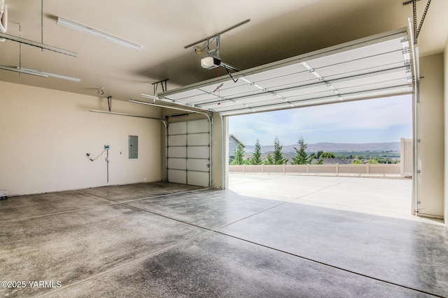 302 N 90th Ave, Yakima, WA 98908 - garage featuring electric panel, a mountain view, and a garage door opener