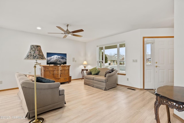 living room with recessed lighting, visible vents, a ceiling fan, light wood-type flooring, and baseboards