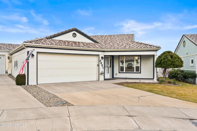 ranch-style house featuring a garage, a tile roof, a front lawn, and concrete driveway