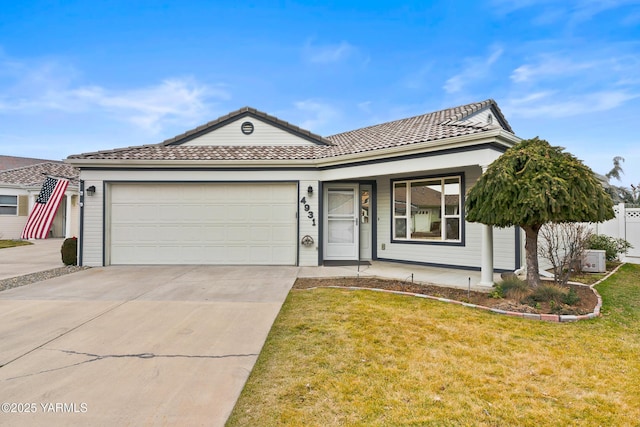 single story home with concrete driveway, a tile roof, an attached garage, covered porch, and a front lawn