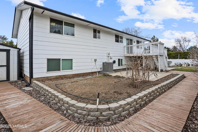 4704 W Prasch Ave, Yakima, WA 98908 - back of property featuring an outbuilding, stairway, a wooden deck, a storage unit, and central AC