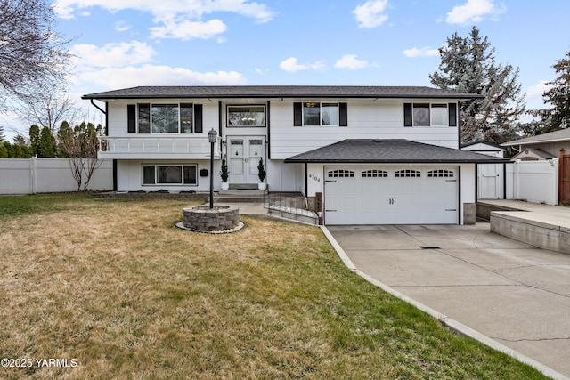 4704 W Prasch Ave, Yakima, WA 98908 - raised ranch featuring a front yard, fence, a garage, and concrete driveway