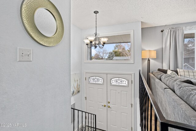 4704 W Prasch Ave, Yakima, WA 98908 - entryway featuring a notable chandelier and a textured ceiling