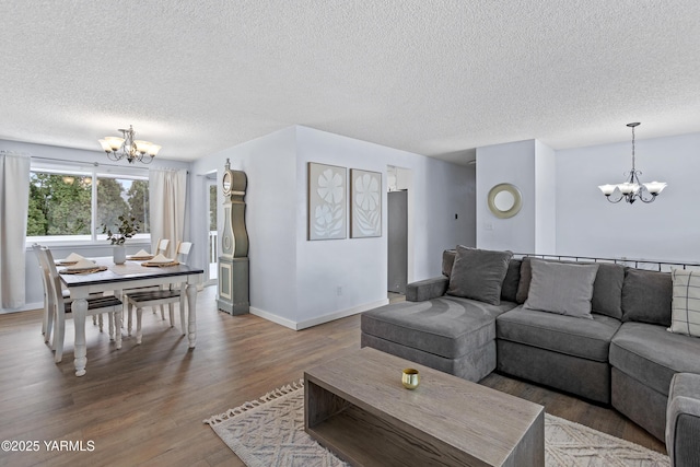 4704 W Prasch Ave, Yakima, WA 98908 - living room with baseboards, a textured ceiling, wood finished floors, and an inviting chandelier