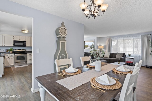 4704 W Prasch Ave, Yakima, WA 98908 - dining space with a textured ceiling, a healthy amount of sunlight, dark wood-style floors, and an inviting chandelier
