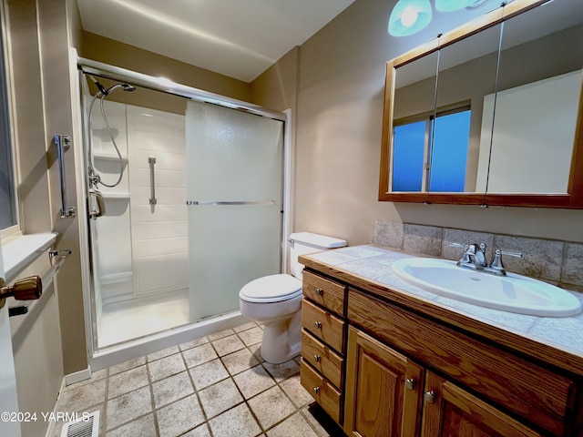 full bath with toilet, a stall shower, visible vents, and vanity