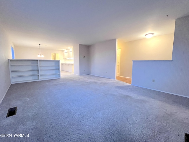 carpeted empty room featuring visible vents