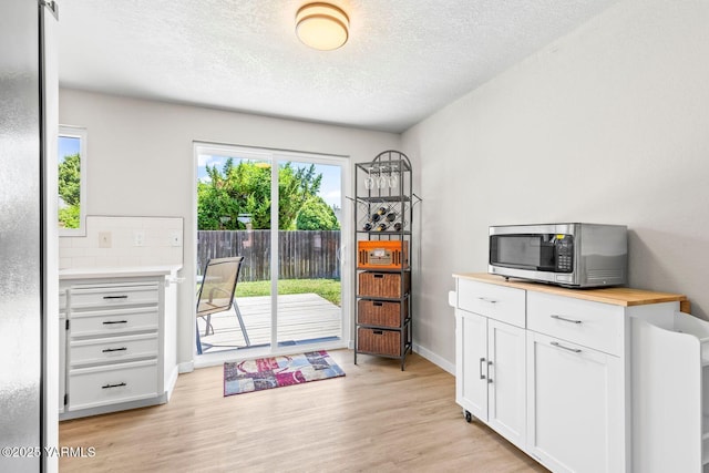 1805 S 66th Ave, Yakima, WA 98908 - doorway to outside featuring light wood-style flooring and a textured ceiling