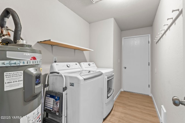 1805 S 66th Ave, Yakima, WA 98908 - laundry room with electric water heater, washer and clothes dryer, and light wood finished floors