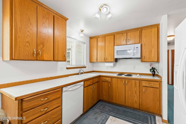 516 N Elm St, Toppenish, WA 98948 - kitchen with white appliances, brown cabinetry, and light countertops