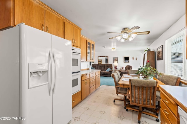 516 N Elm St, Toppenish, WA 98948 - kitchen featuring white appliances, a ceiling fan, open floor plan, light flooring, and light countertops