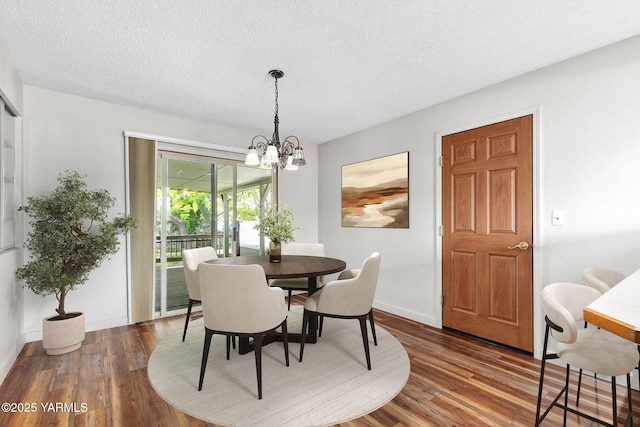 3204 Clinton Way, Yakima, WA 98902 - dining room featuring wood finished floors, a textured ceiling, and a chandelier