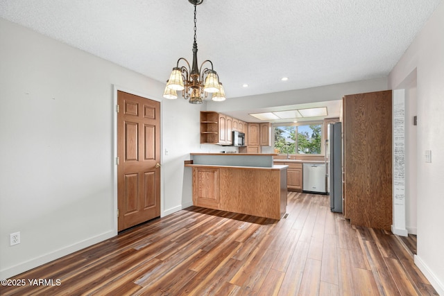 3204 Clinton Way, Yakima, WA 98902 - kitchen with stainless steel dishwasher, refrigerator, a peninsula, open shelves, and black microwave