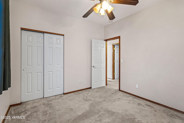 unfurnished bedroom with baseboards, a closet, and light colored carpet